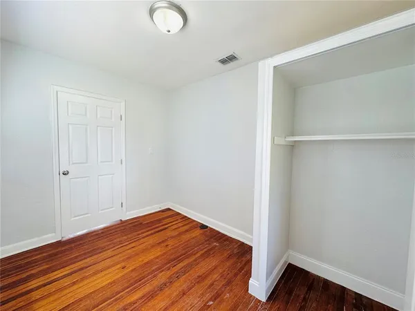 a view of a room with wooden floor