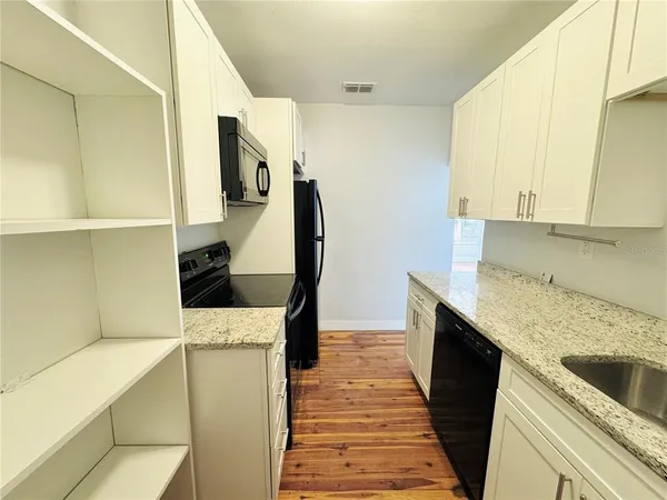 a kitchen with a sink and a stove top oven