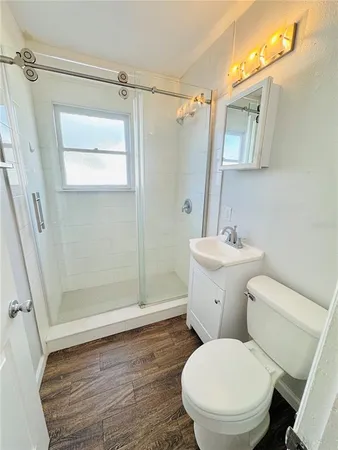 a bathroom with a toilet and a shower