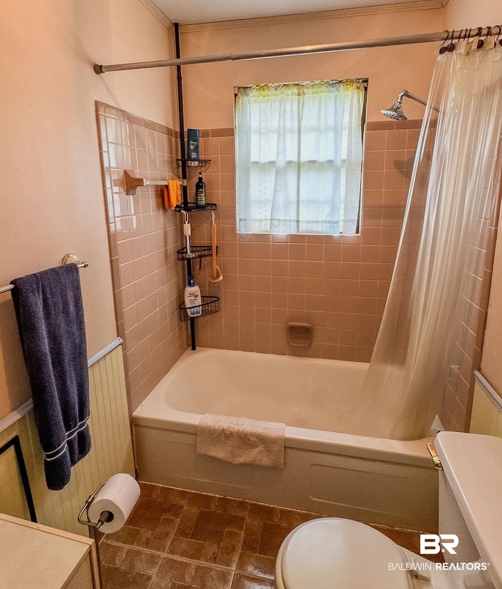 1456 Allen Walker Road Grove Hill, AL 36451 - Photo 26 of 28 Bathroom with shower / tub combo with curtain, wainscoting, and tile patterned floors