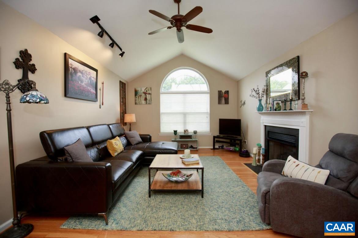 166 Oak View Road Barboursville, VA 22923 - Photo 19 of 46 a living room with furniture a large window and a fireplace