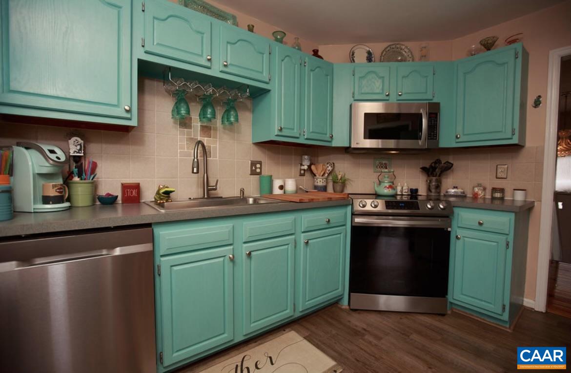 166 Oak View Road Barboursville, VA 22923 - Photo 4 of 46 a kitchen with green cabinets and a stainless steel appliances
