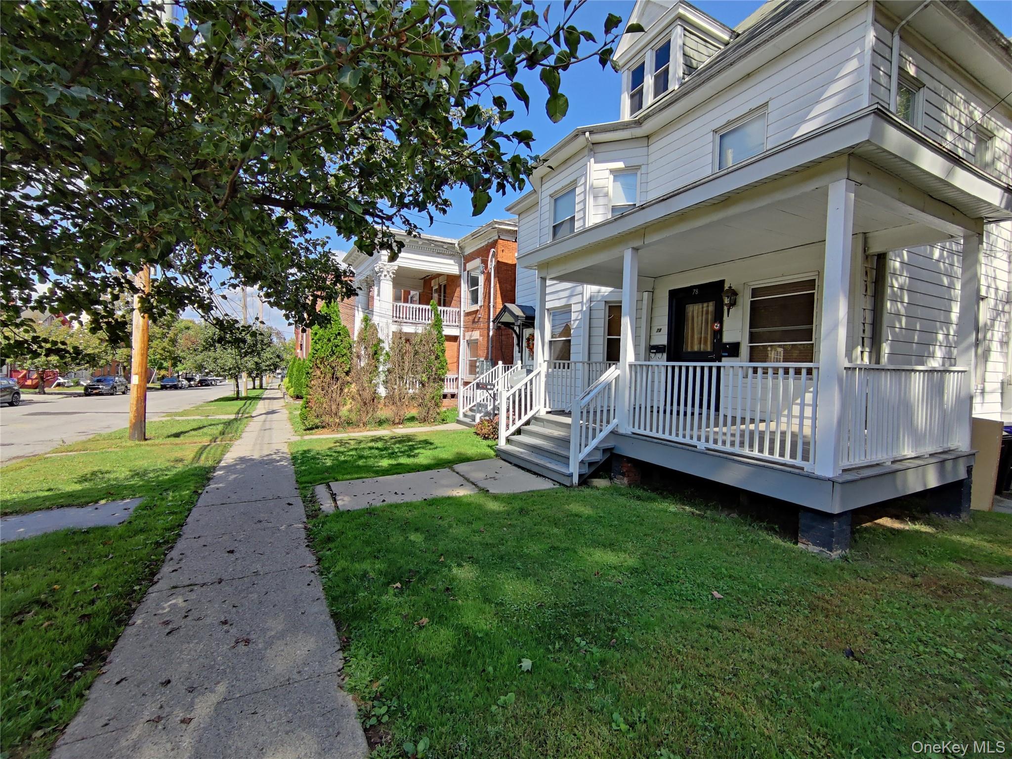 a view of a house with a yard and deck