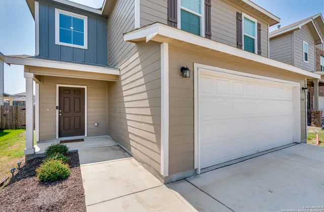 a view of a house with a small yard