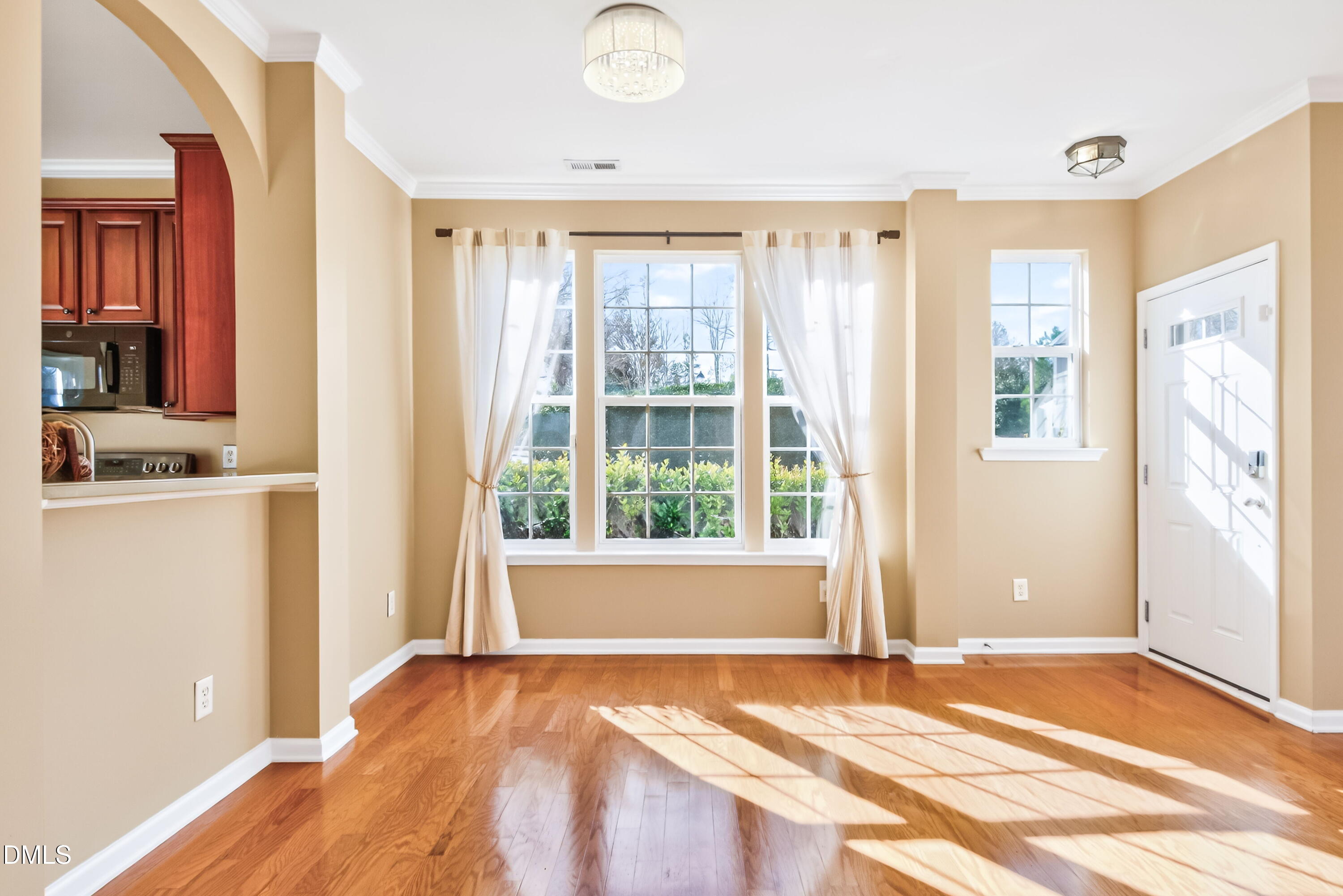 102 Grey Elm Trail Durham, NC 27713 - Photo 12 of 38 a view of an empty room with wooden floor and a window