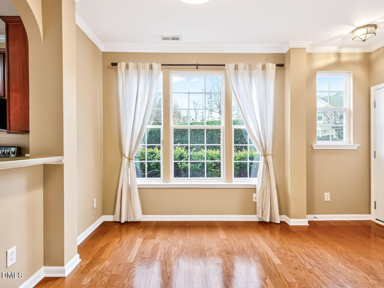 102 Grey Elm Trail Durham, NC 27713 - Photo 13 of 38 a view of an empty room with a window and hardwood floor