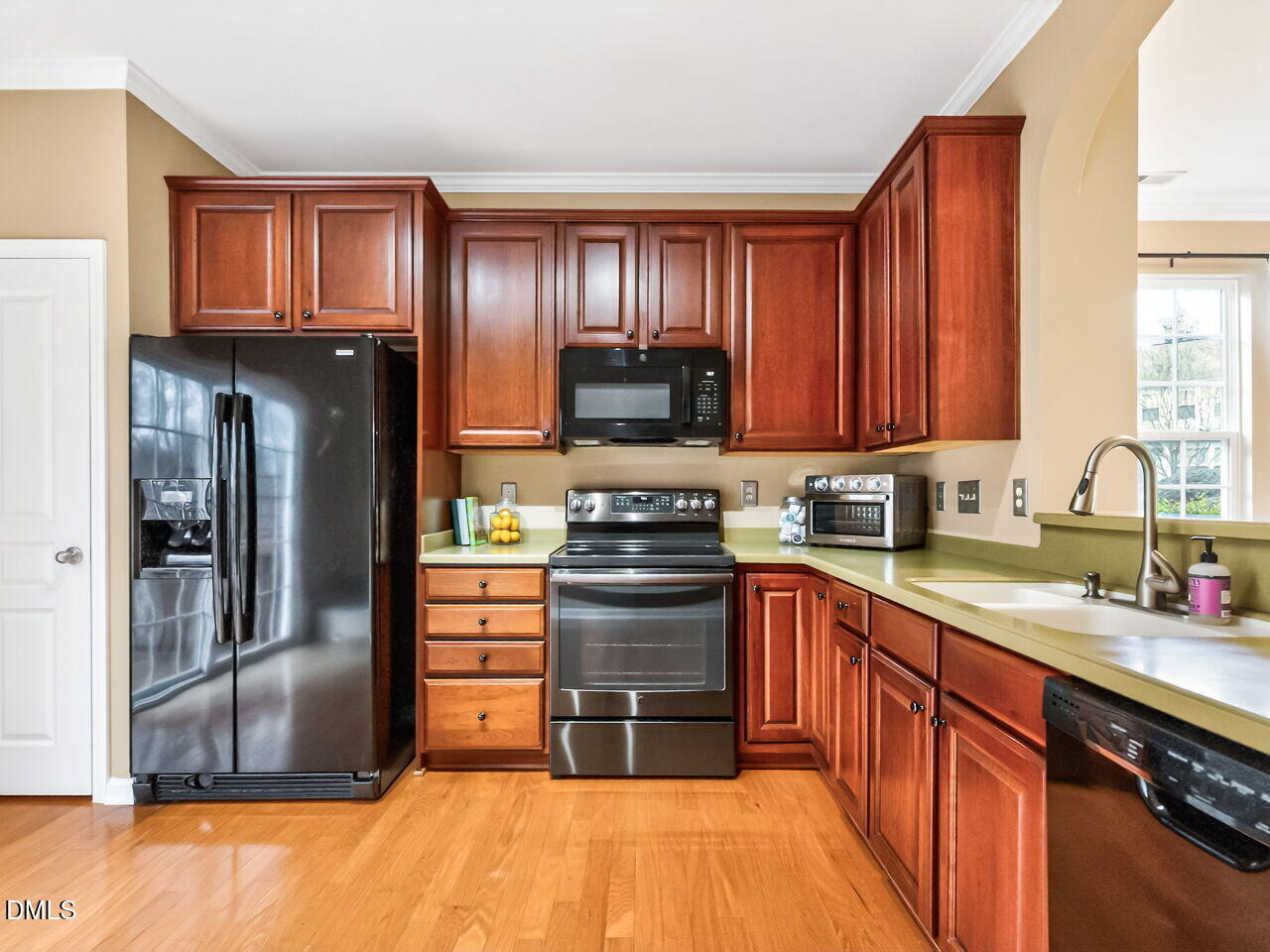 102 Grey Elm Trail Durham, NC 27713 - Photo 15 of 38 a kitchen with stainless steel appliances granite countertop a stove top oven a sink and dishwasher