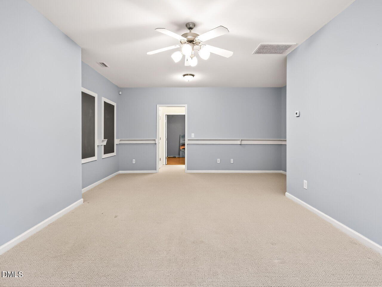 102 Grey Elm Trail Durham, NC 27713 - Photo 30 of 38 an empty room with chandelier fan and windows