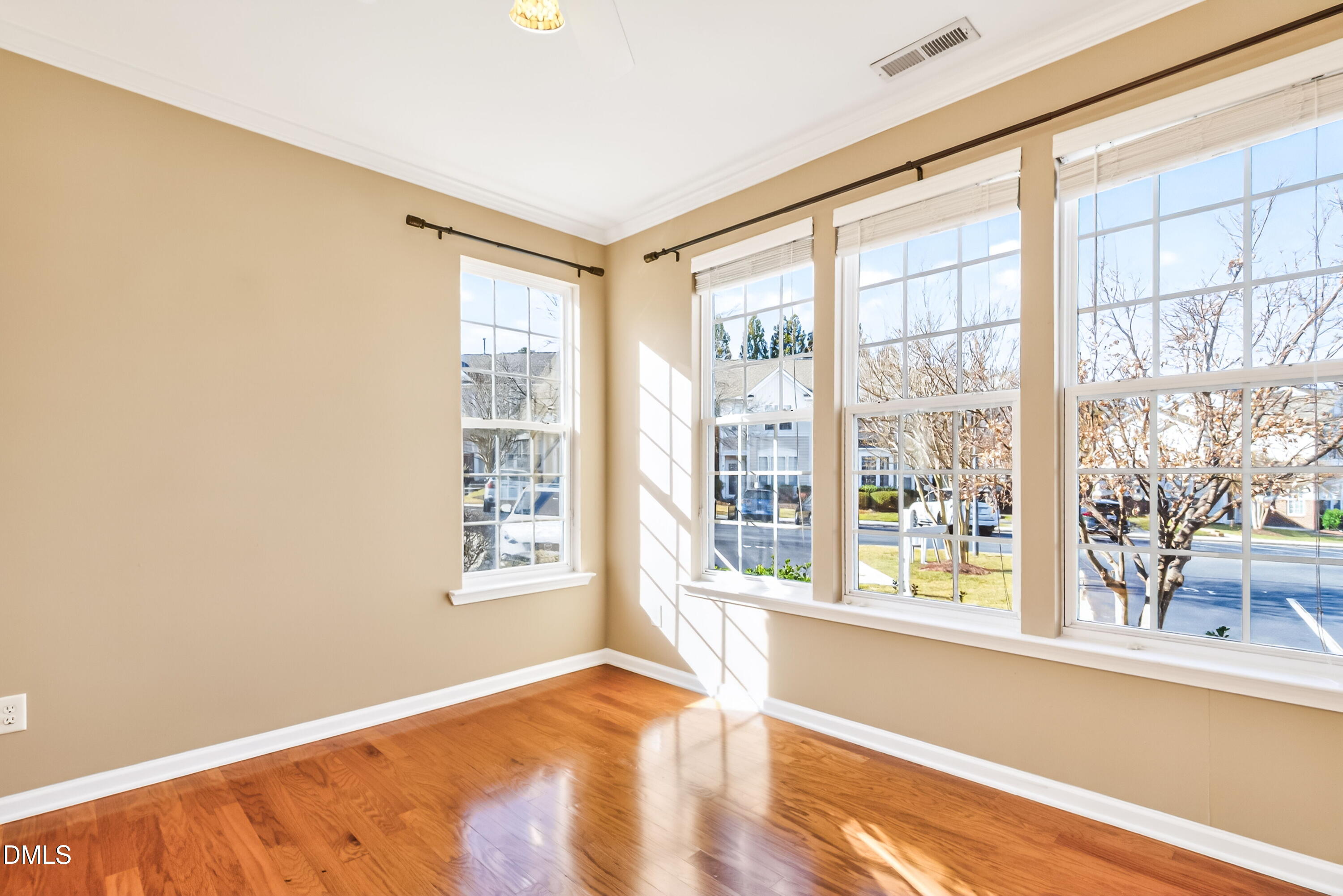 102 Grey Elm Trail Durham, NC 27713 - Photo 7 of 38 a view of an empty room with a window and wooden floor