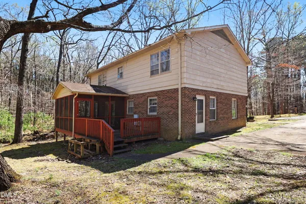 a view of a house with a yard covered in snow