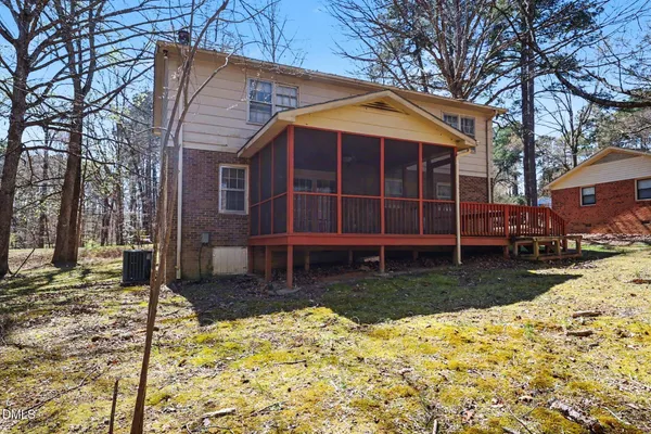 a front view of a house with a yard covered with snow