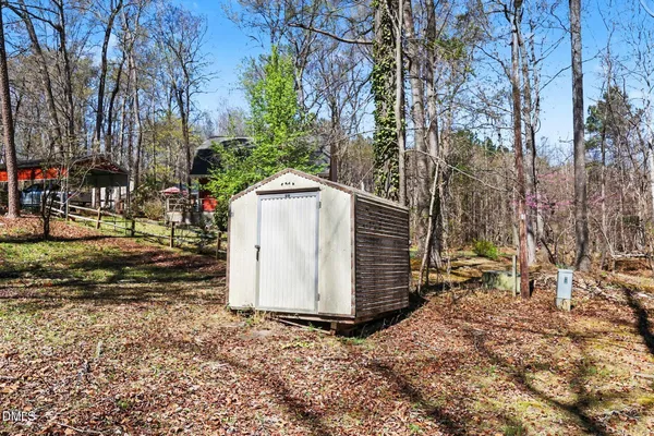 a view of a barn in the middle of a yard