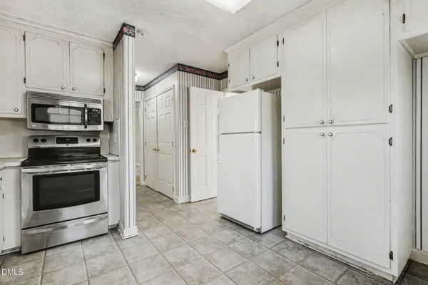 a kitchen with stainless steel appliances a refrigerator sink and cabinets