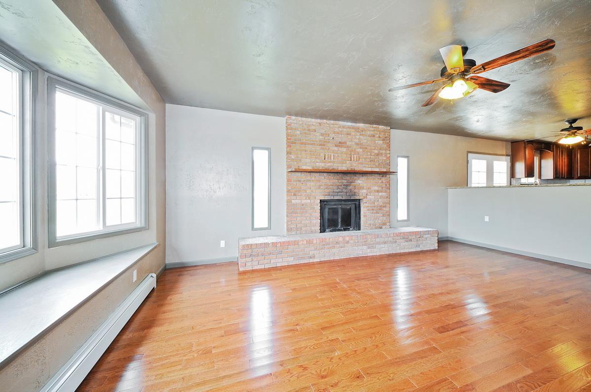 3453 1/2 G Road Clifton, CO 81520 - Photo 3 of 21 an empty room with windows and fireplace