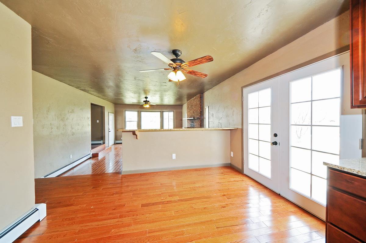 3453 1/2 G Road Clifton, CO 81520 - Photo 6 of 21 wooden floor in an empty room with a window