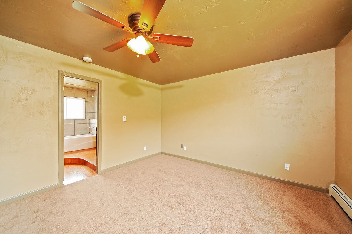 3453 1/2 G Road Clifton, CO 81520 - Photo 7 of 21 wooden floor in an empty room with a window