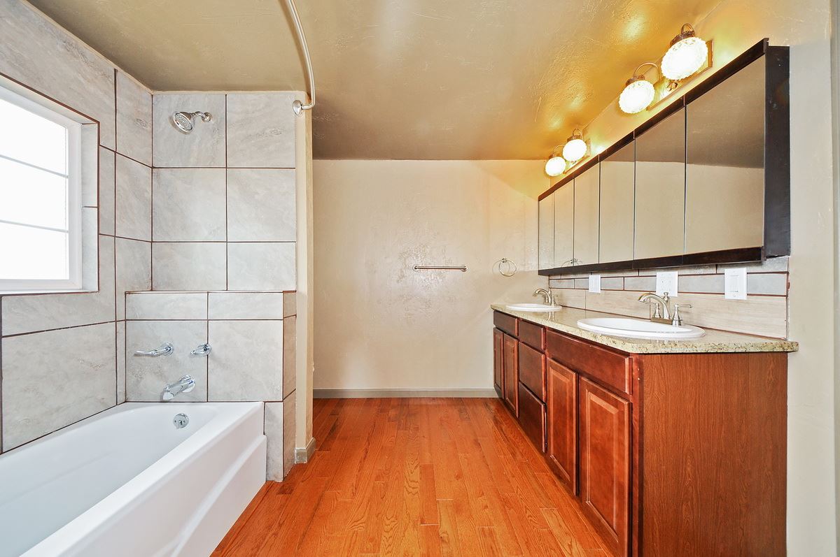 3453 1/2 G Road Clifton, CO 81520 - Photo 8 of 21 a bathroom with a granite countertop tub sink and mirror