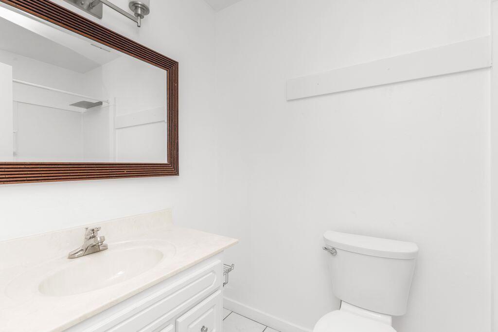 1313 Finck Road Niceville, FL 32578 - Photo 11 of 16 a bathroom with a toilet a sink and mirror