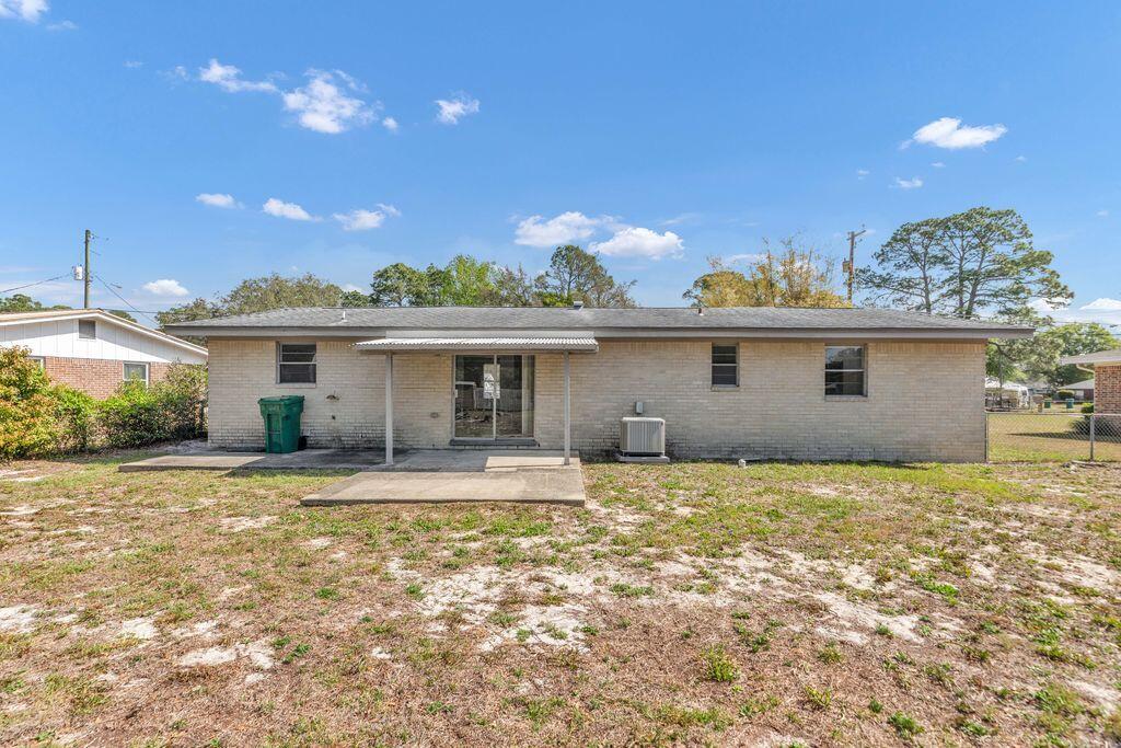 1313 Finck Road Niceville, FL 32578 - Photo 16 of 16 a view of a house with a yard and potted plants