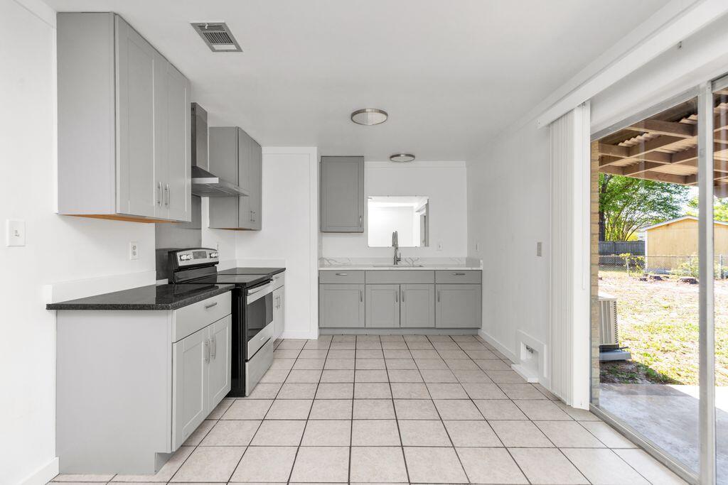 1313 Finck Road Niceville, FL 32578 - Photo 5 of 16 a kitchen with a stove a sink and a refrigerator