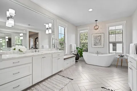 a spacious bathroom with a granite countertop tub sink and mirror