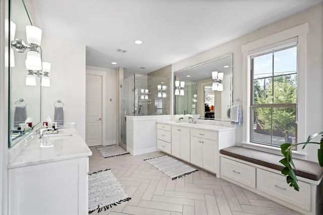 a large bathroom with a large window vanity and sink