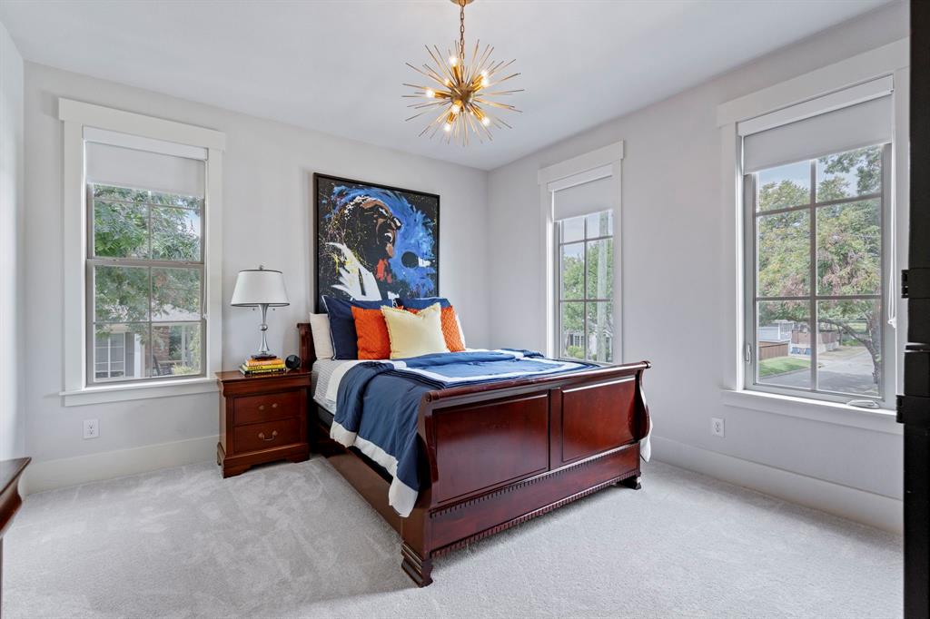 7102 Coronado Avenue Dallas, TX 75214 - Photo 16 of 30 a bed sitting in a bedroom next to a window