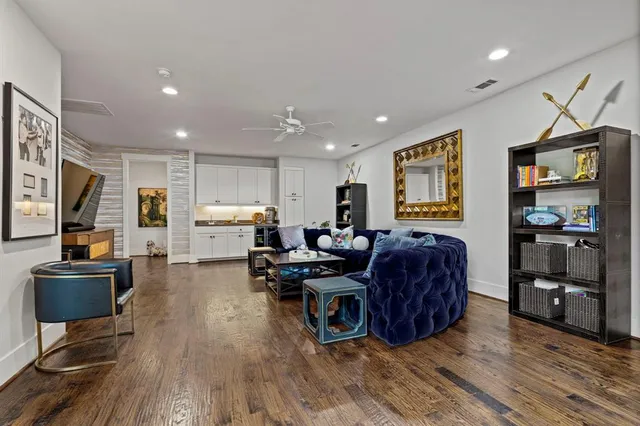 a living room with furniture and wooden floor
