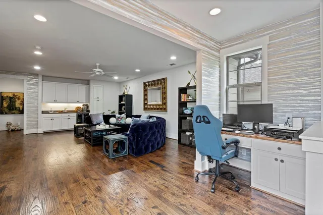 a living room with furniture kitchen view and a flat screen tv