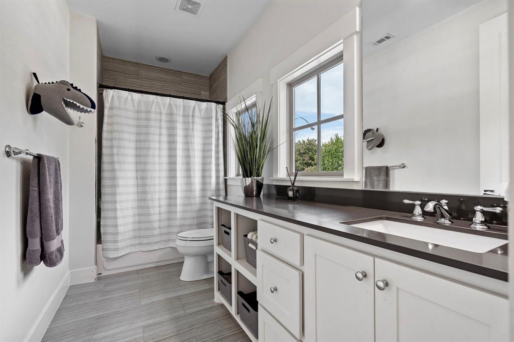 7102 Coronado Avenue Dallas, TX 75214 - Photo 19 of 30 a bathroom with a double vanity sink toilet and shower