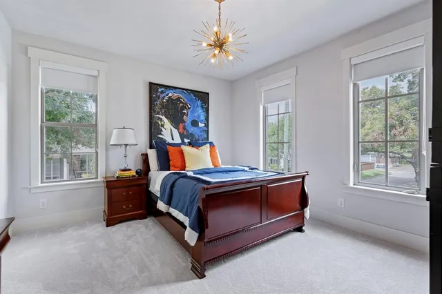 a bed sitting in a bedroom next to a window