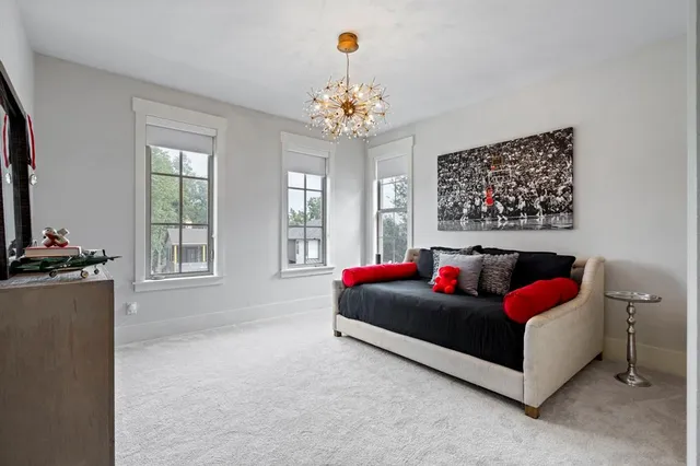 a living room with furniture and a chandelier