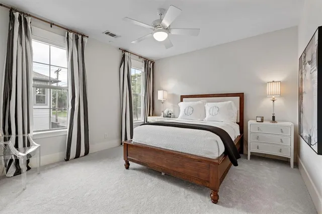 a bed sitting in a room next to a balcony