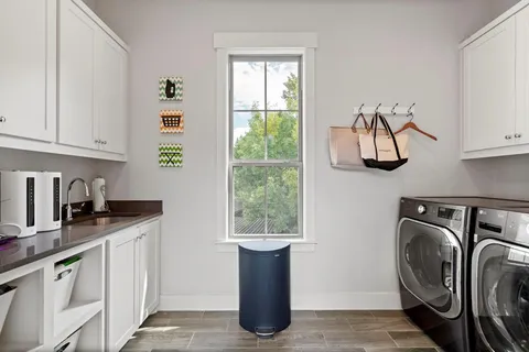 a kitchen with a sink cabinets and a window