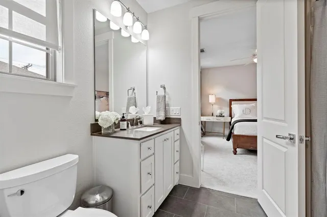 a en suite bathroom with a toilet a sink and mirror