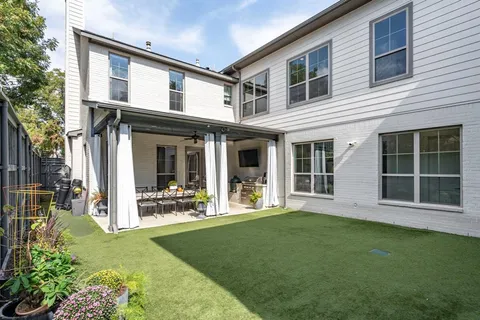 front view of a brick house with a yard