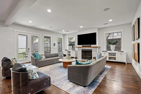 a living room with furniture a fireplace and a flat screen tv