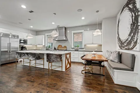 a living room with stainless steel appliances kitchen island granite countertop furniture and a kitchen view