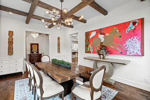 a view of a dining room with furniture a chandelier and wooden floor
