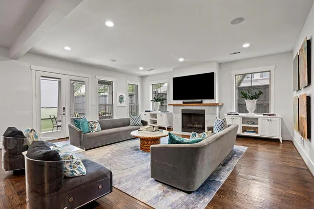 a living room with furniture a fireplace and a flat screen tv