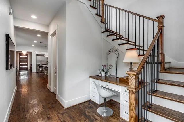 a view of entryway and hall with wooden floor