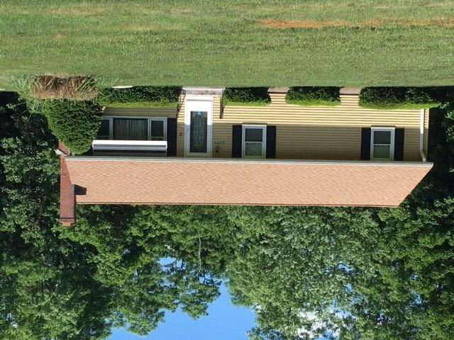 a aerial view of a house with a yard