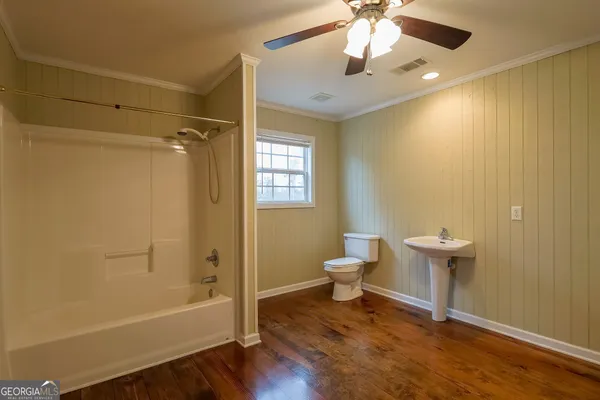 a view of a room with kitchen island stainless steel appliances wooden floor and living room view