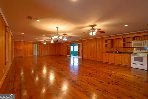 a view of a room with wooden floor and windows