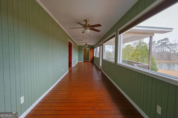 a view of a room with wooden floor