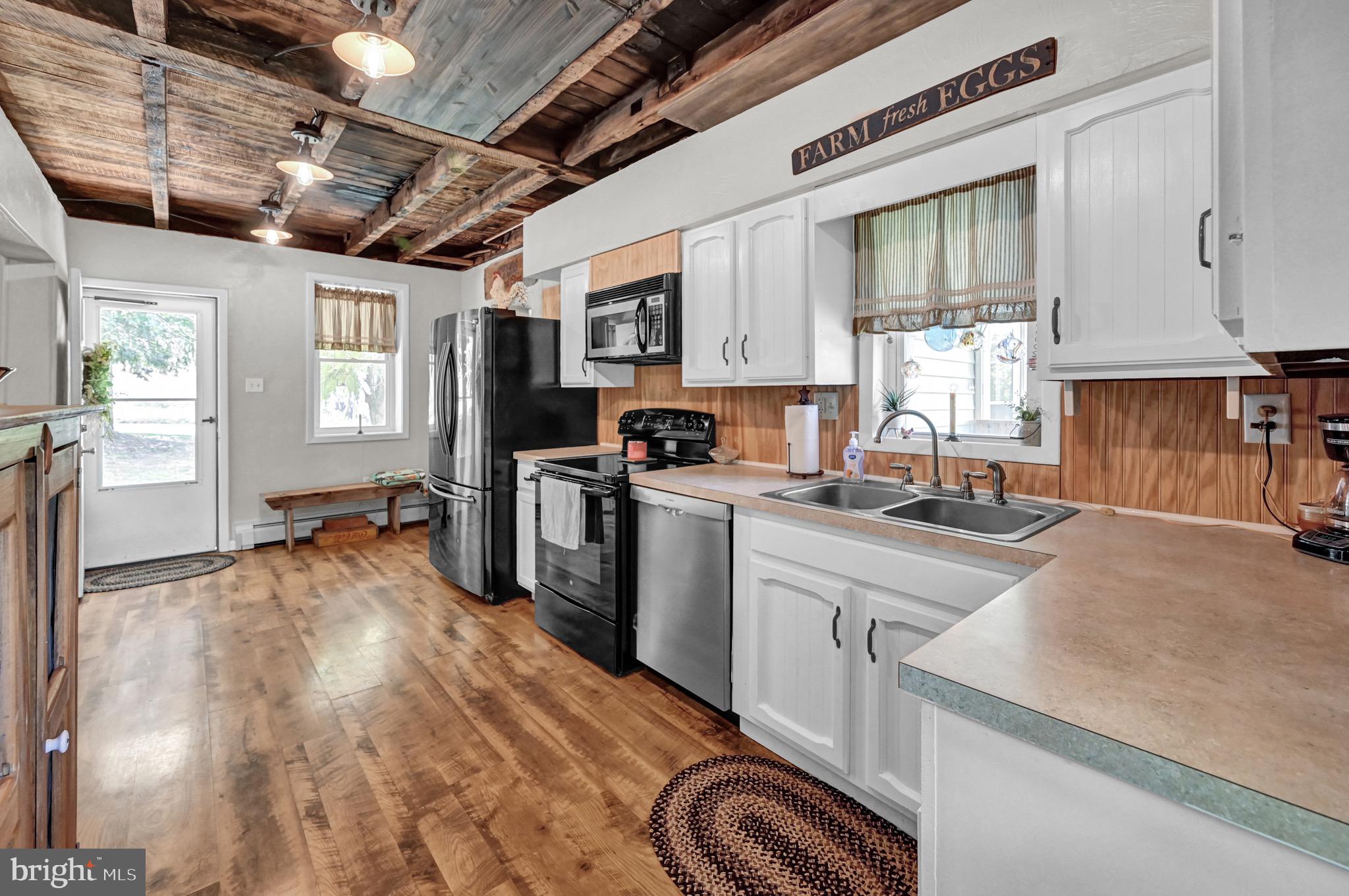 410 Days Mill Road York, PA 17403 - Photo 20 of 38 a kitchen with stainless steel appliances granite countertop a sink a stove cabinets counter space and a window