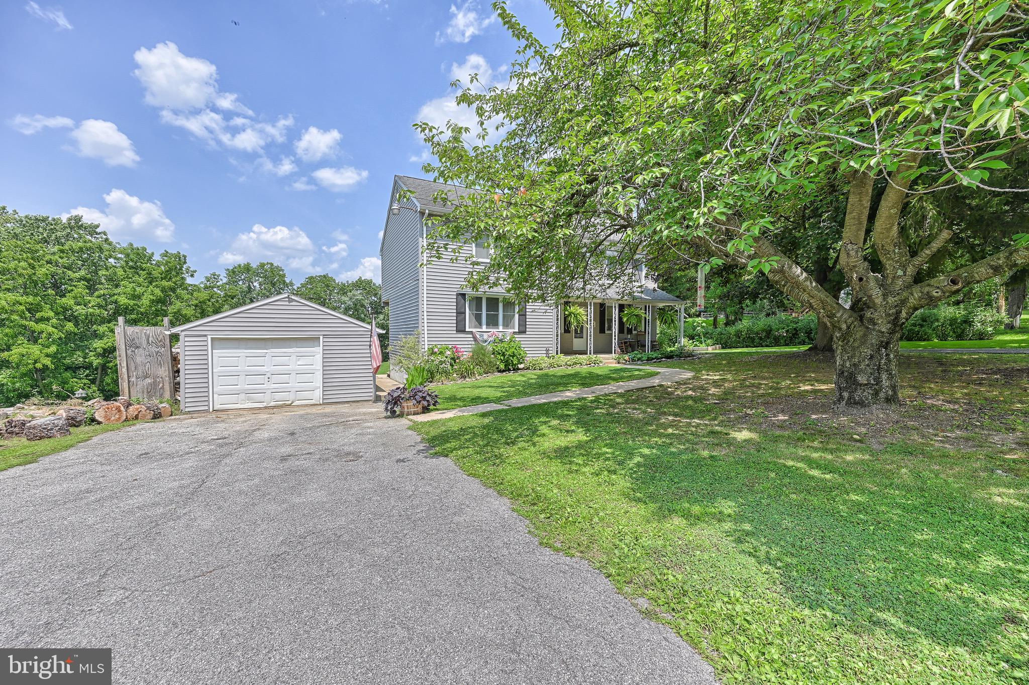 410 Days Mill Road York, PA 17403 - Photo 4 of 38 a front view of a house with garden