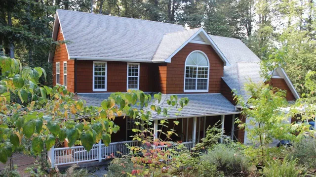 a front view of a house with a yard garage and outdoor seating