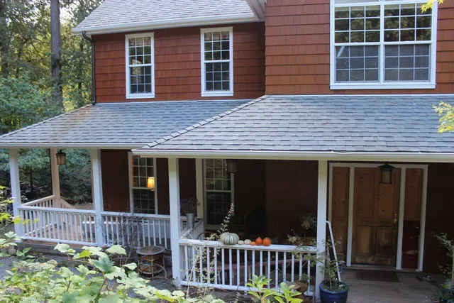 a front view of a house with a garden