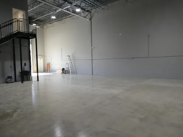 a view of a water heater room with a hallway